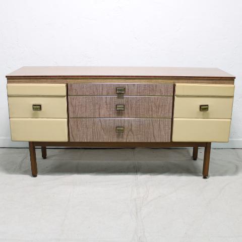 Formica & Vinyl Sideboard: Danish Modern style sideboard from England by Stonehill Furniture Co. Has a Formica case and drawers with vinyl doors, brass adjustable feet, Brass colored hardware and trim.