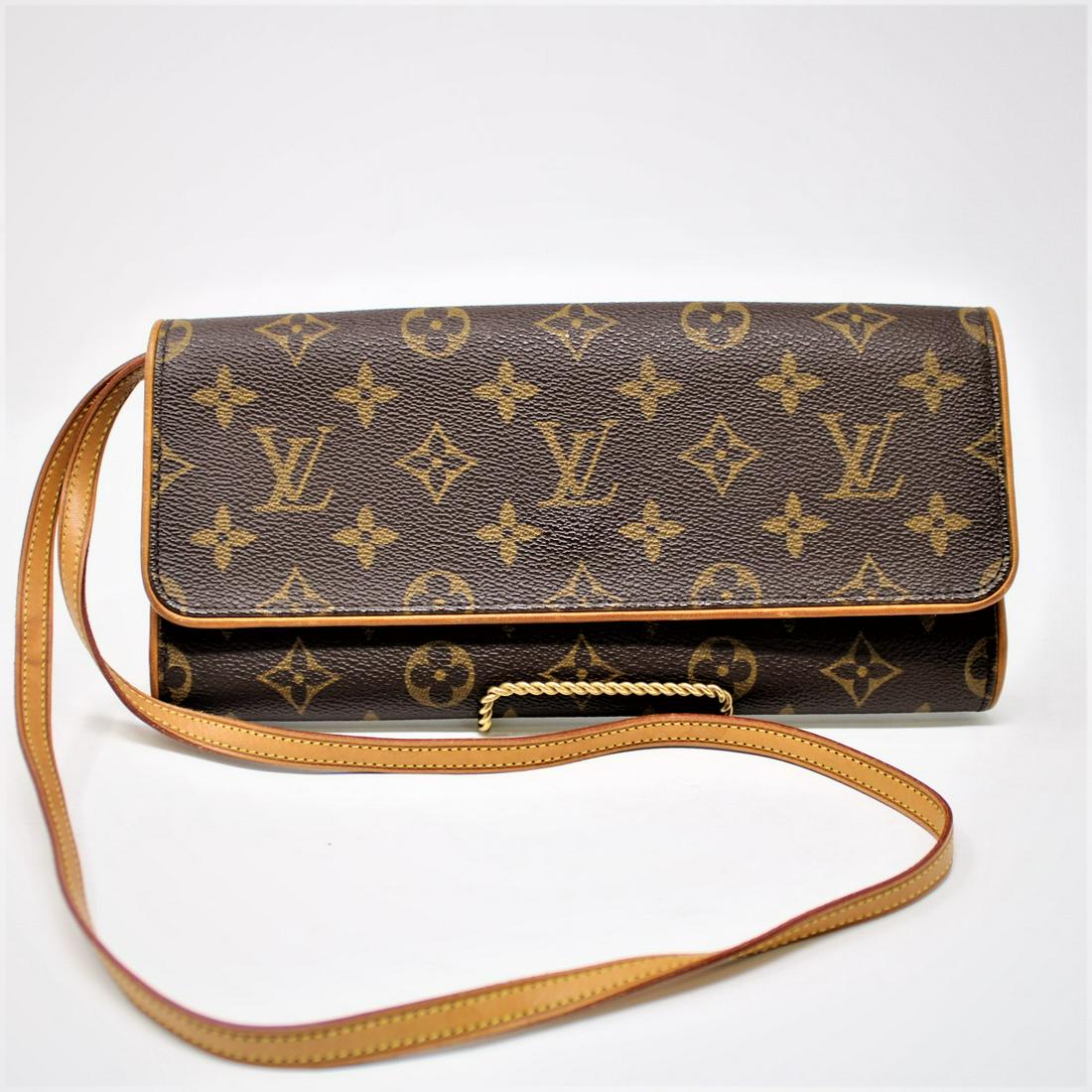 Louis Vuitton Twin GM: Genuine Pre-Owned Louis Vuitton Twin GM in Brown Monogram Canvas in AB condition. Date Code is FL0021. Measurements: 25*11,5*3cm (Length * Height * Width). This lot includes a certificate of authentic