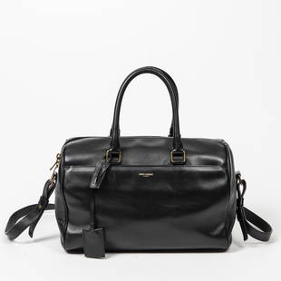 Yves St-Laurent Duffle 6: Genuine Pre-Owned Yves St-Laurent Duffle 6 in Black Smooth Leather in A condition. Date Code is 322049-529258. Includes Dustbag. Measurements: 30*22*12cm (Length * Height * Width). This lot includes a