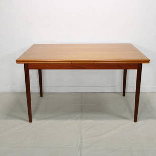 Danish Modern Draw Leaf Dining Table: This Danish modern draw leaf table came to us via England. It is 30 in tall x 51 long when closed / 93 long when open x 34 in wide