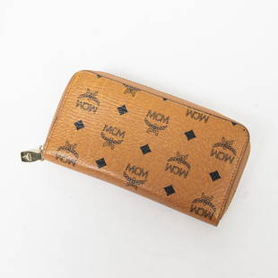 MCM Zip Around Wallet - Cognac Color: Preowned designer wallet- MCM Brand - Zip around wallet in Cognac Visetos Coated Canvas - includes Certificate of Authenticity from BrandCo Paris.