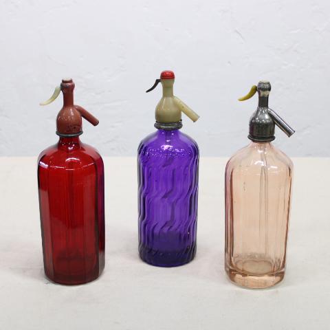 Collection of three European soda bottles: Set of 3 vintage European Seltzer Bottles in Ruby Red, Amethyst, and Light Pink. Measurement and weight are per bottle, bidding is for the set