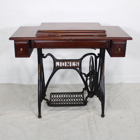 Treadle Base Sewing Machine: This is a Jones brand sewing machine with an iron treadle base.