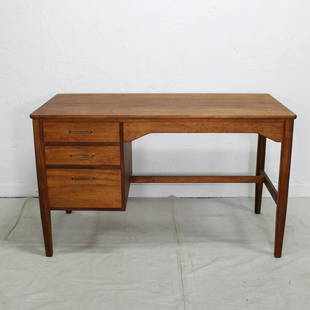 Mid Century Modern Desk: This Danish Modern Style desk is from England and made by L M FURNITURE LTD WALLINGFORD . It features three drawers with metal handles and has the original metal tag in the top drawer