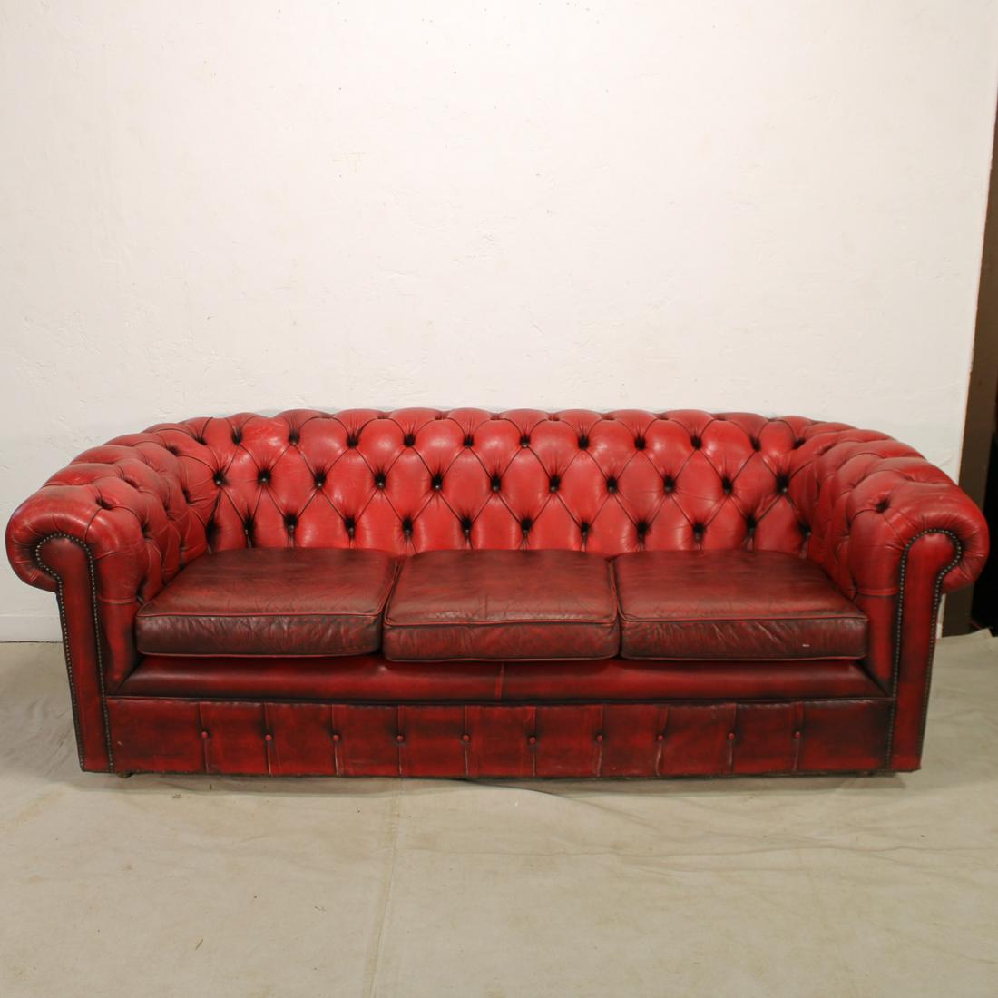 English Oxblood Red Chesterfield Sofa: English oxblood red chesterfield 3 seat leather sofa on bun feet. Red leather to the Tufted Areas & Cushions.