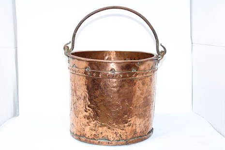 French Copper Bucket: Rustic French copper pot with dark iron handle. Rivets all around some showing an aged copper patina including those on the bottom, wonderful well worn texture all around as well