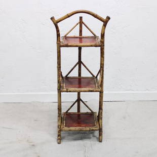 Three tier bamboo cake stand: Three tier bamboo cake stand with all brass caps & a red washed checkerboard finish to some of the tops. Does not fold.