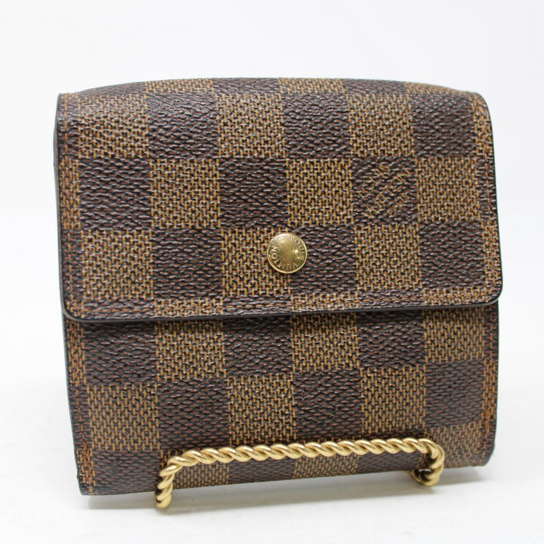 Louis Vuitton Elise in Damier Ebene: Genuine Pre-Owned Louis Vuitton Elise in Brown Damier Ebene in AB condition. Date Code is SP0014. Measurements: 11*10*2cm (Length * Height * Width). This lot includes a certificate of authenticity.