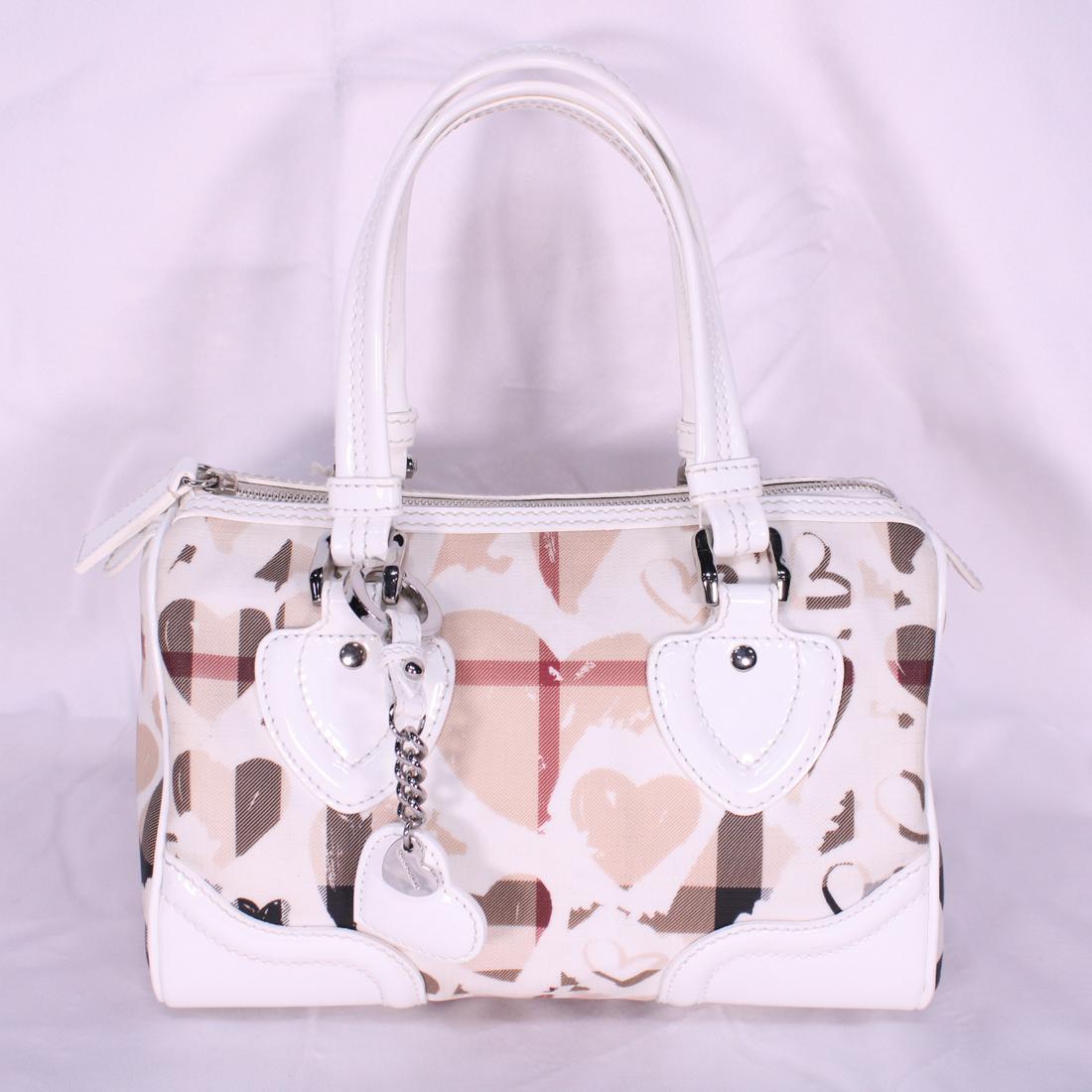 Burberry Limited Edition Heart Charm Boston in: Genuine Pre-Owned Burberry Limited Edition Heart Charm Boston in Beige Valentine's Heart Check Canvas in A condition. Date Code is ITHOLLEA27CAMA. Includes Heart Charm, Dustbag. Measurements: 27*16*15
