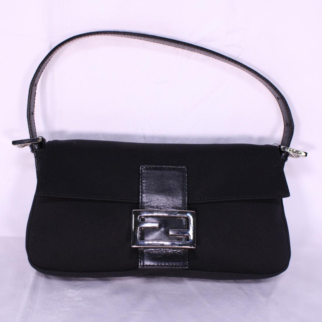 Fendi Small Baguette in: Genuine Pre-Owned Fendi Small Baguette in Black in A condition. Date Code is . This lot includes a certificate of authenticity.