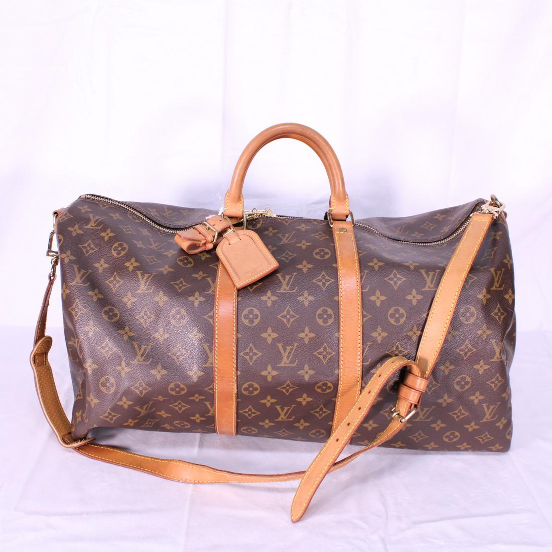 Louis Vuitton Keepall Bandouliere 55 in Monogram Canvas: Genuine Pre-Owned Louis Vuitton Keepall Bandouliere 55 in Brown Monogram Canvas in AB condition. Date Code is VI0972Strap, Luggage Tag, Handle Strap. This lot includes a certificate of authenticity.