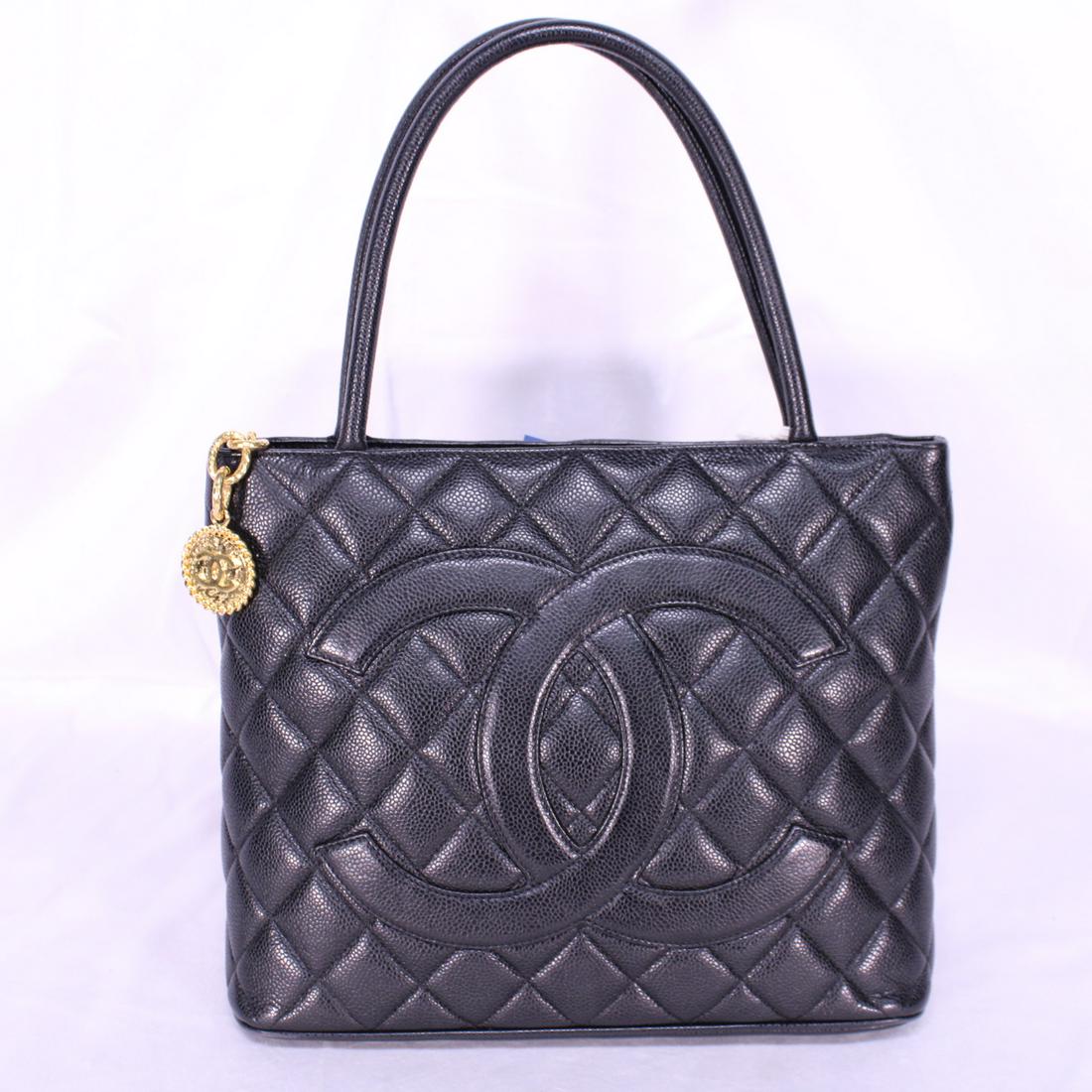 Chanel Medallion in Quilted Caviar Leather: Genuine Pre-Owned Chanel Medallion in Black Quilted Caviar Leather in AA condition. Date Code is 6673058. Includes Sticker, Dustbag. Measurements: 30*25*14cm (Length * Height * Width). This lot includ