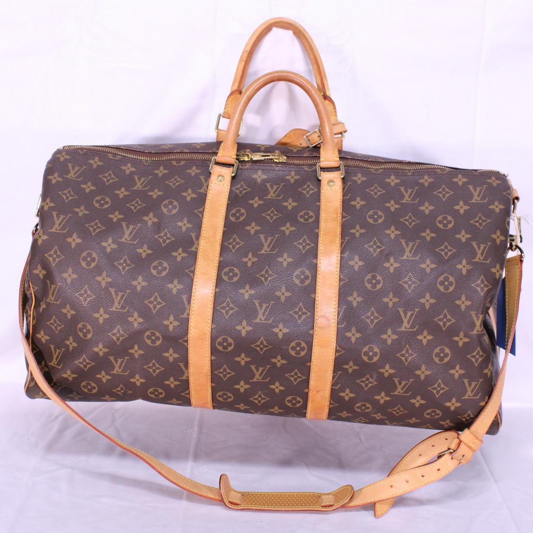 Louis Vuitton Keepall Bandouliere 55 in Monogram Canvas: Genuine Pre-Owned Louis Vuitton Keepall Bandouliere 55 in Brown Monogram Canvas in AB condition. Date Code is FL0040Strap, Luggage Tag. This lot includes a certificate of authenticity.
