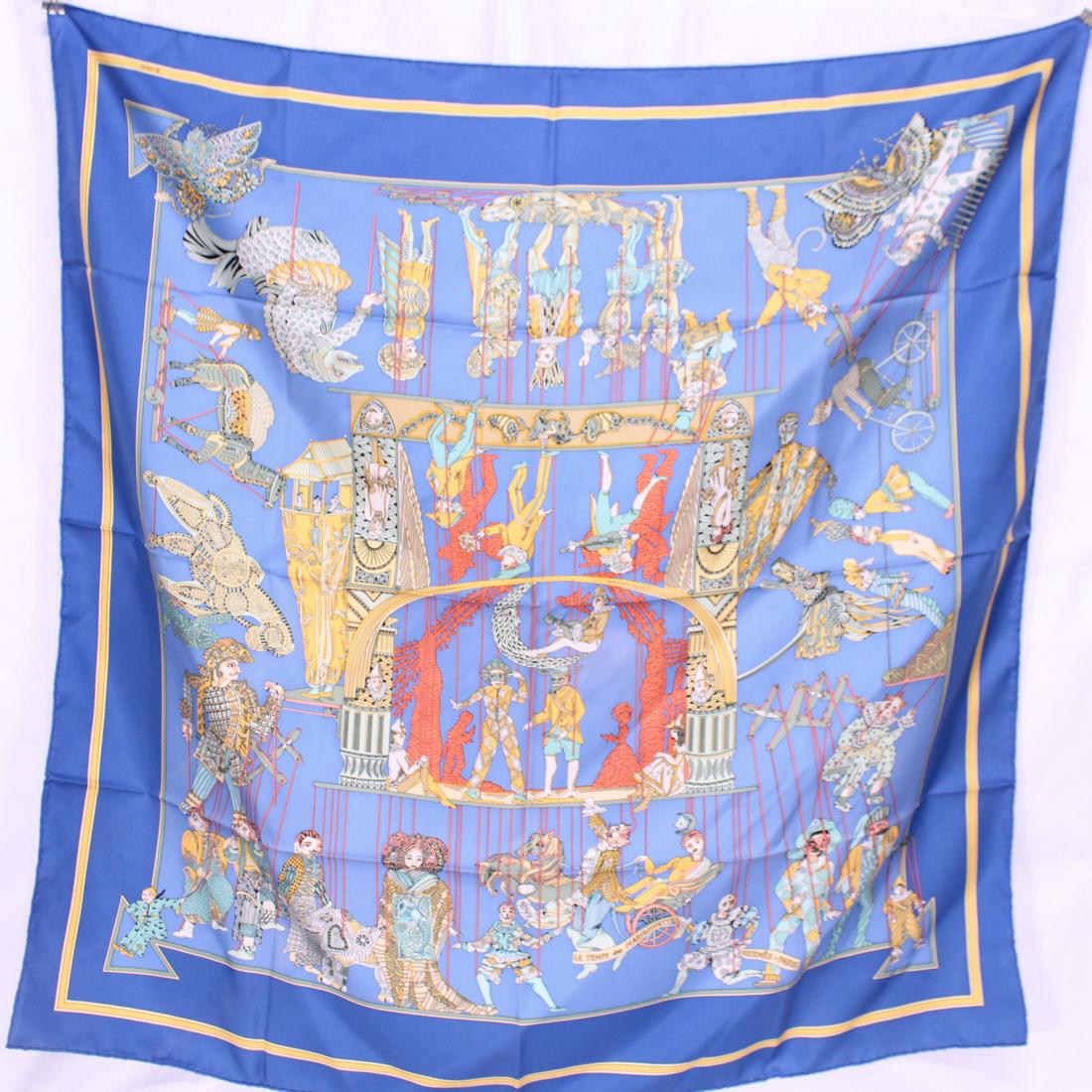 Hermes Scarf "Le Temps des Marionnettes" by Annie: Genuine Pre-Owned Hermes Scarf "Le Temps des Marionnettes" by Annie Faivre in Blue/Yellow/Green/Red/Orange 100% Twill Silk in AA condition. Measurements: 90*90cm (Length * Height * Width). This lot in