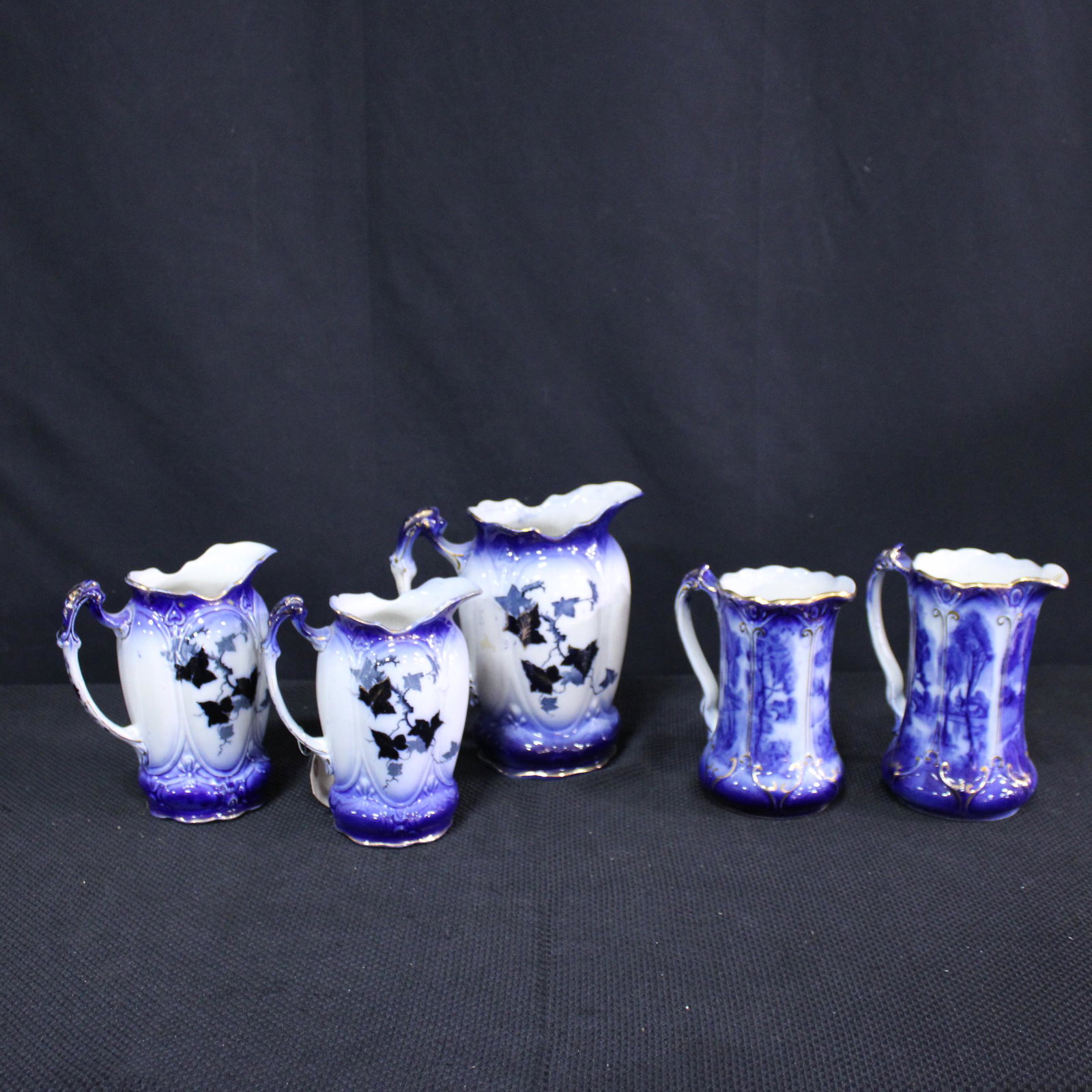 5 Flow Blue Pitchers: 5 Flow Blue Pitchers - largest is 10 in tall x 8 x 6 -