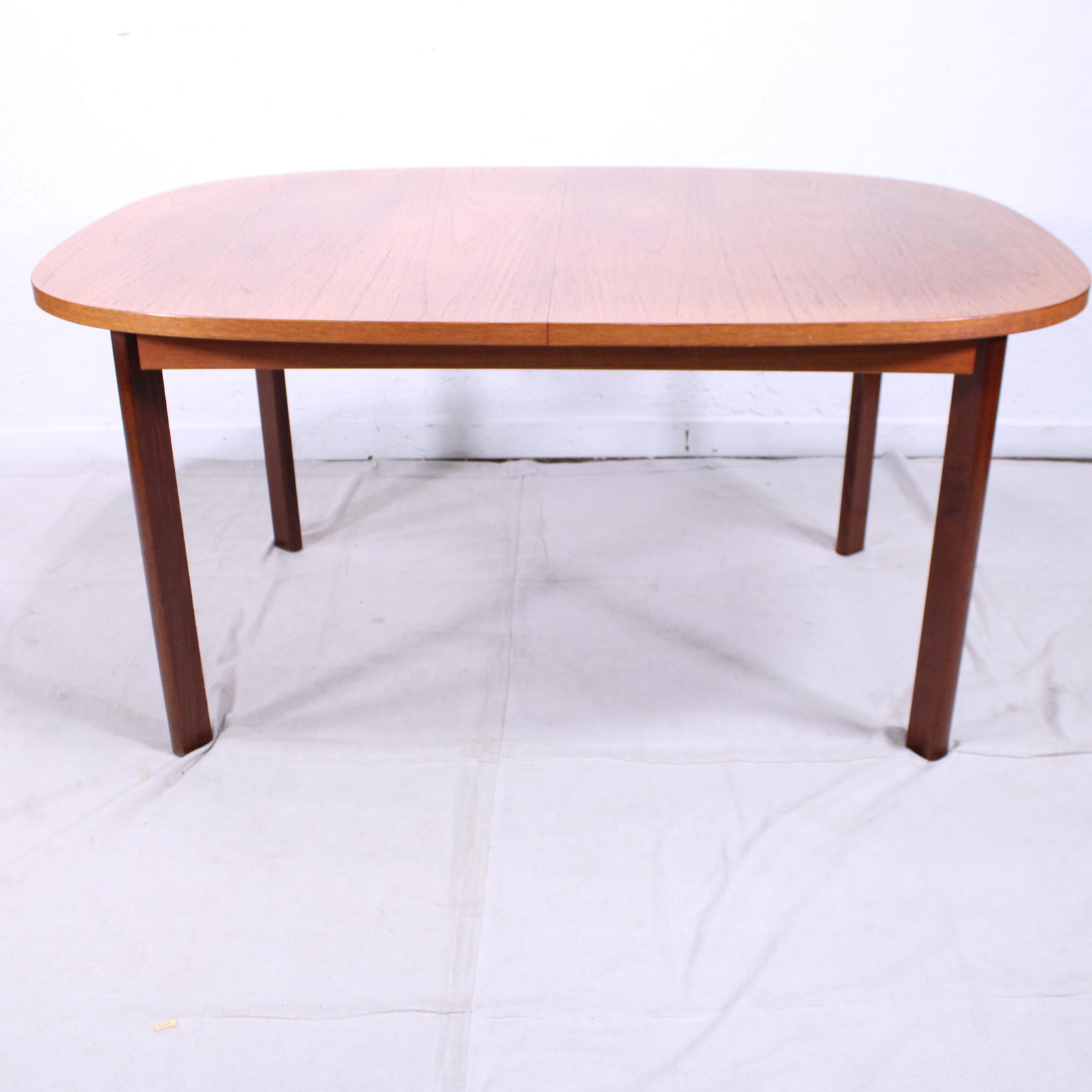 Oval Mid Century Modern Teak Dining Table By G-plan: This Danish Modern Style Teak Dining Table includes a pop-out butterfly style leaf & is made by Mid Century Modern Furniture Maker G Plan ( Gplan ). 29 in tall x 60 in long (leaf adds 18 in ) x 42