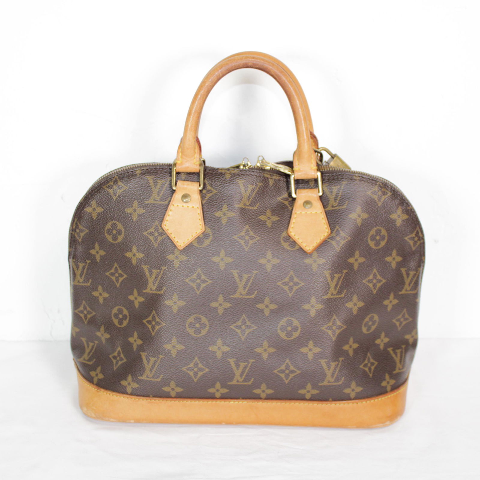 Louis Vuitton Alma PM in Monogram Canvas: Genuine Pre-Owned Louis Vuitton Alma PM in Brown Monogram Canvas in B condition. Date Code is VI1916 This lot includes Cadenas with a key. Measurements: 29*23*15cm (Length * Height * Width). This lot