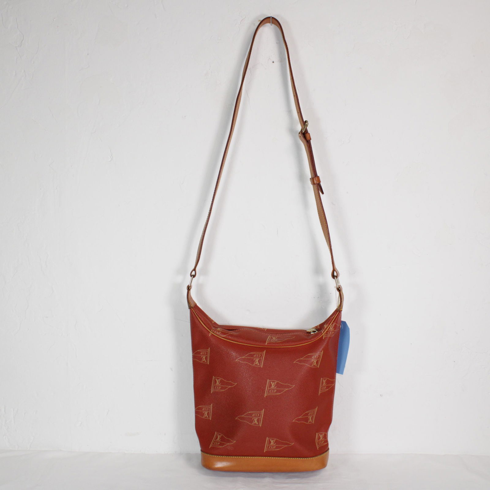 Louis Vuitton Ltd. Edition "LV Cup" Le Touquet in "LV: Genuine Pre-Owned Louis Vuitton Ltd. Edition "LV Cup" Le Touquet in Red "LV Cup" Monogram Canvas in A condition. Date Code is MI1914. Measurements: 28*23*10cm (Length * Height * Width). This lot inclu