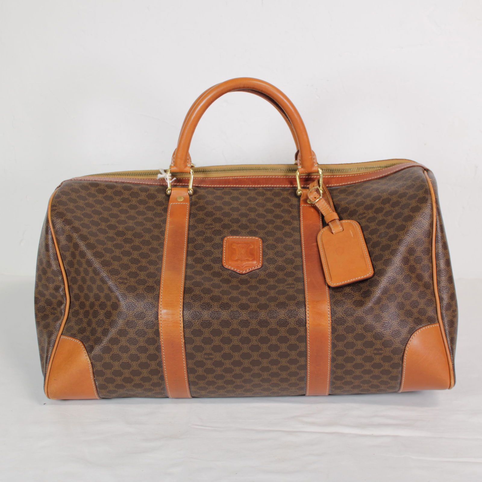 Celine Boston Tote in Macadam Coated Canvas: Genuine Pre-Owned Celine Boston Tote in Brown Macadam Coated Canvas in AB condition. Date Code is MC97/2 This lot includes Key in Clochette, Cadena, Handle Strap. Measurements: 45*24*23cm (Length * H