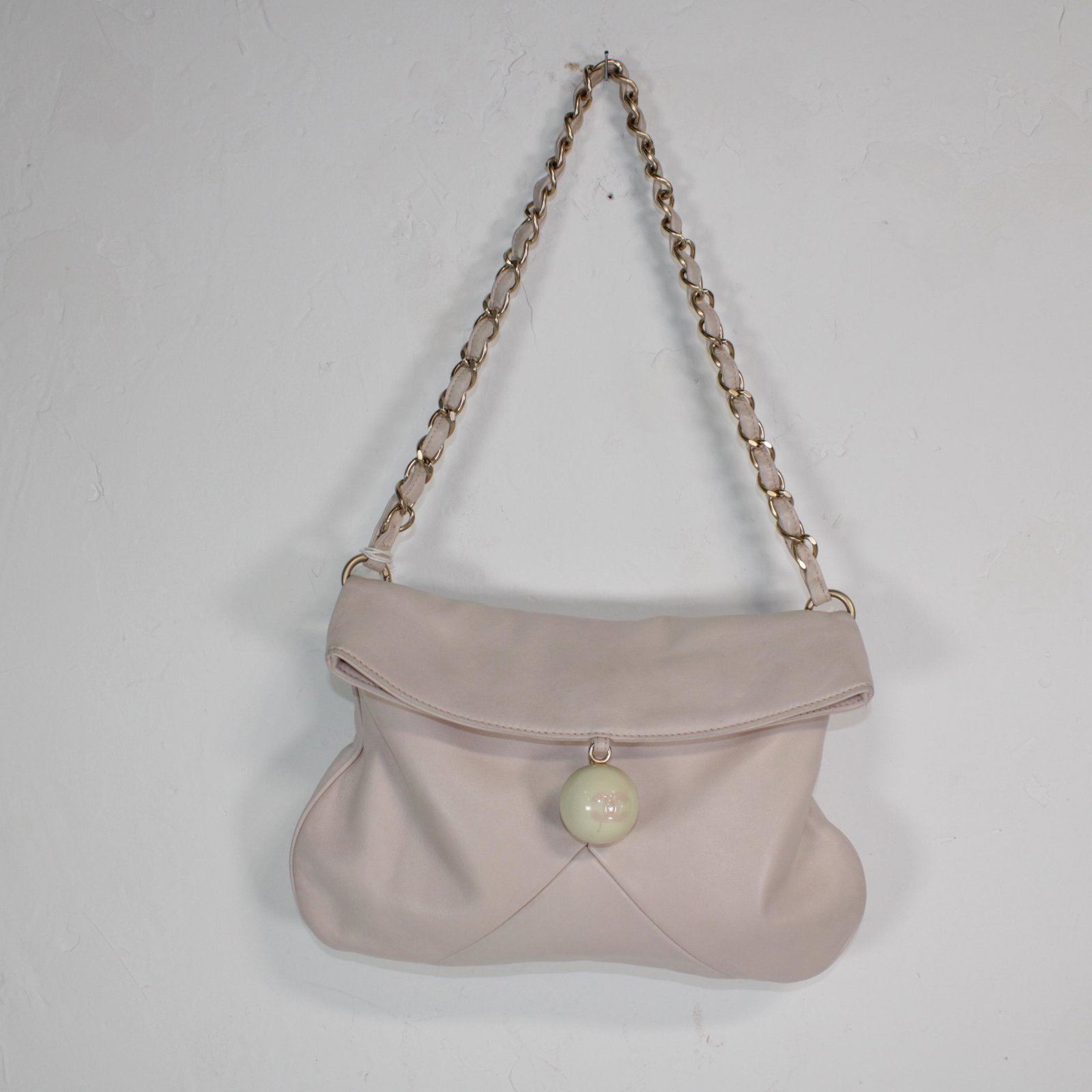 Chanel Coco Ball Bag in Small Grained Leather: Genuine Pre-Owned Chanel Coco Ball Bag in Beige Small Grained Leather in AB condition. Date Code is 8898658. Measurements: 28*30*2cm (Length * Height * Width). This lot includes a certificate of authe