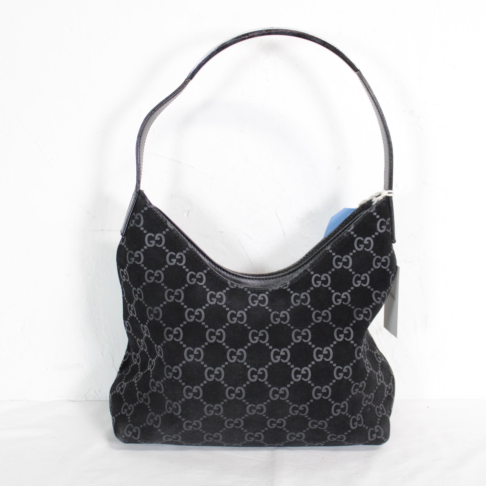 Gucci Metal Handle Shoulder Bag in Monogram Suede: Genuine Pre-Owned Gucci Metal Handle Shoulder Bag in Black Monogram Suede Leather in A condition. Date Code is 001/3778/1705 This lot includes Dustbag. Measurements: 24*23*8cm (Length * Height * Width