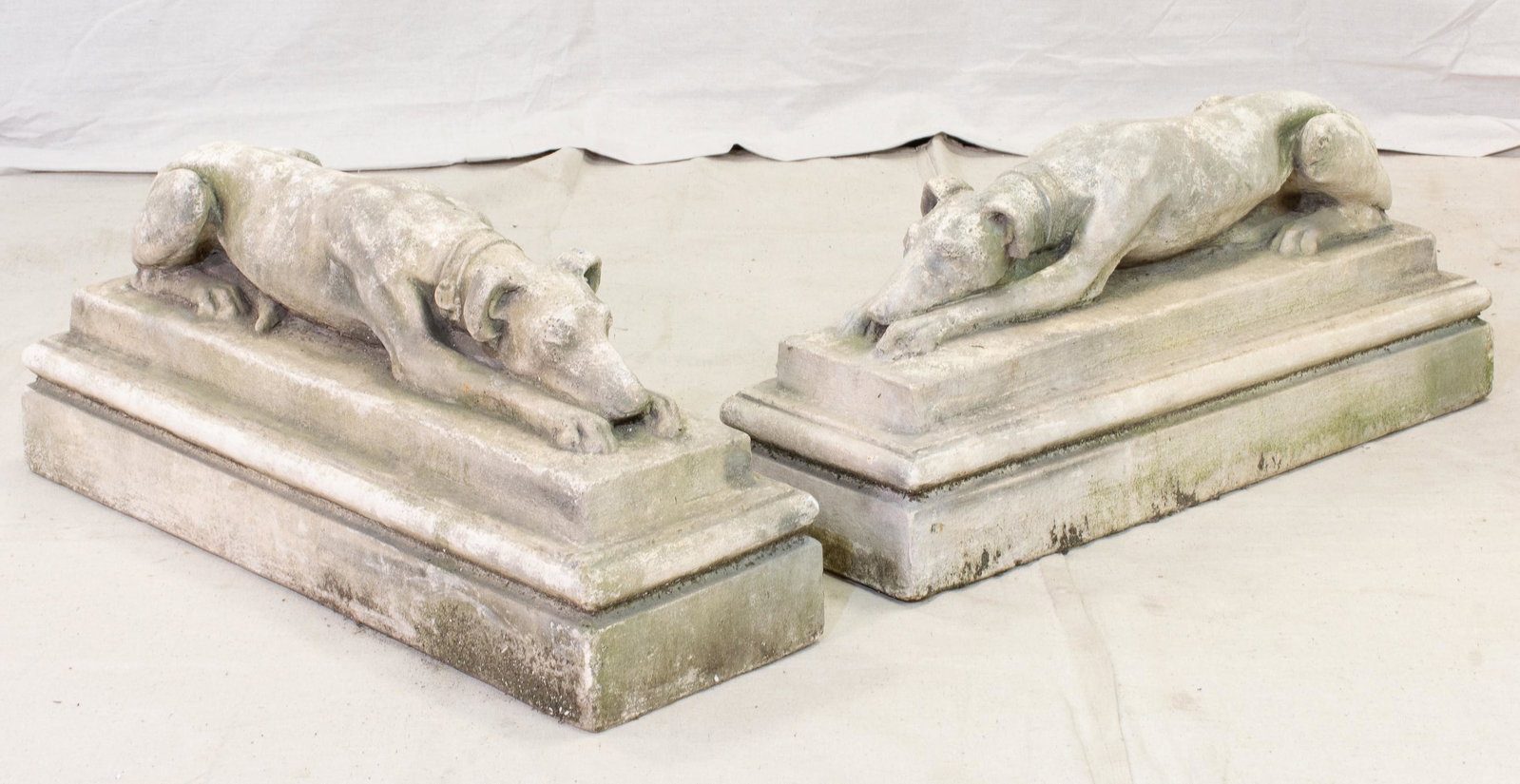 Pair English Stone Whippet Garden Figures: Pair English Stone Whippet Garden Figures - Both in a reclined pose, resting on a raised rectangular base - 14 in tall x 30 x 9