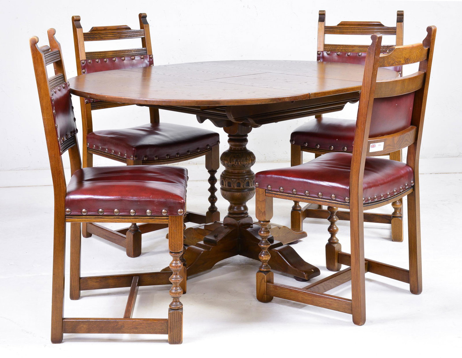 British Round Oak Extendable Table & 4 Chairs: British Round Oak Extendable Table & 4 Red Leather Chairs with Nail Heads - Table is 31 in tall x 44 inch diameter, the leaf is 16 inches wide, Chairs are 41 in tall x 20 x 20