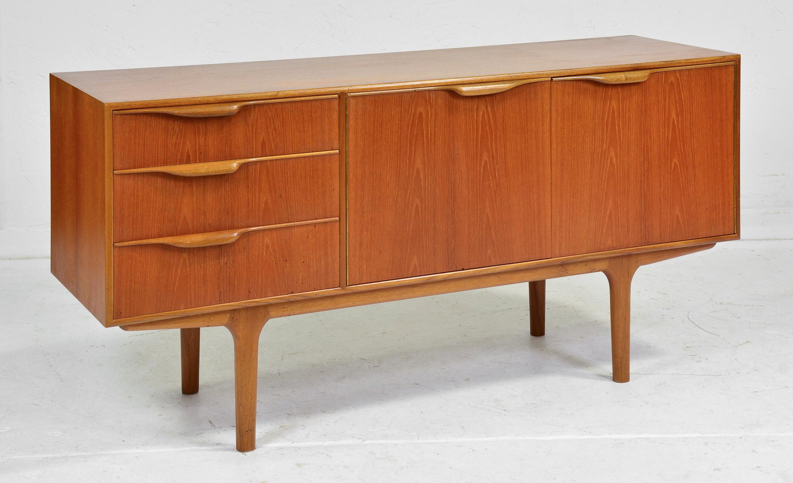 Short Mid Century Sideboard by McIntosh - "Dunvegan": This Danish Modern Style Teak Credenza / Cocktail Sideboard with folded handles is made by Scottish Mid Century Modern Furniture Maker McIntosh. It was designed by Tom Robertson, it is the Short "Dunv