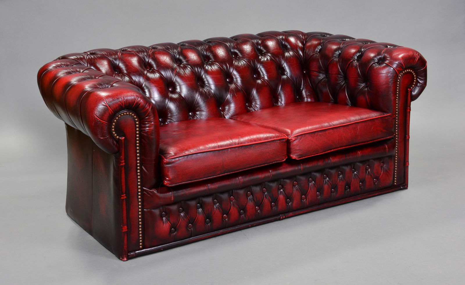 British Red Leather 2 Seater / Loveseat: British Oxblood Leather Button Tufted Chesterfield 2 Seater Sofa / Loveseat with Faux Bamboo Sides - Sofa is 27 in tall x 61 x 38