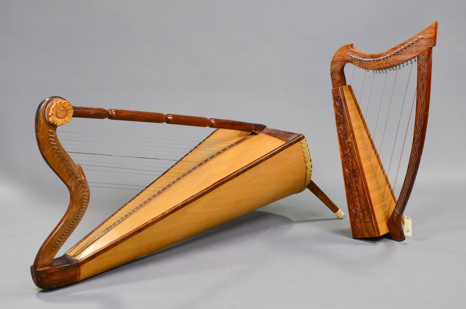 2 Carved Wood Harps: 2 Carved Wood Harps - Smallest is 36 in tall x 19 x 9 - The largest harp is missing one foot and has some damage around the top