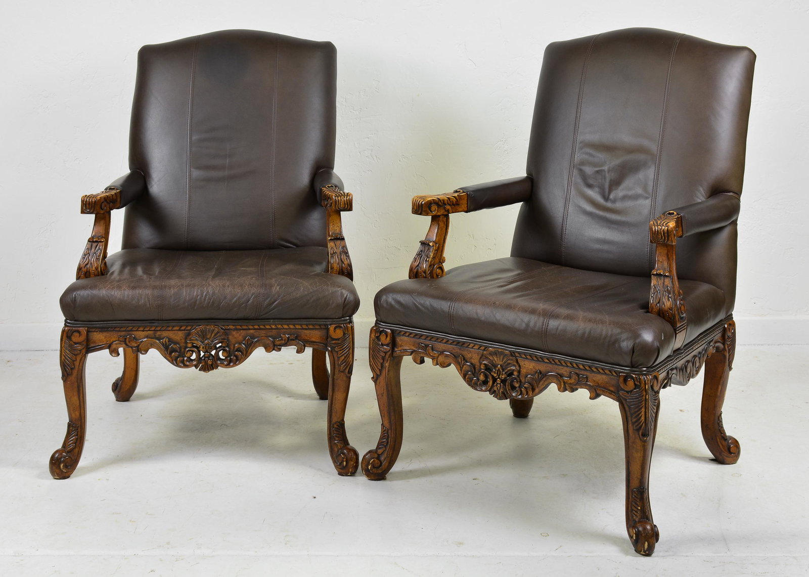 Pair Of French Style Carved Arm Chairs: Pair of French Style Carved Leather Upholstered Arm Chairs - 43 in tall x 30 x 32