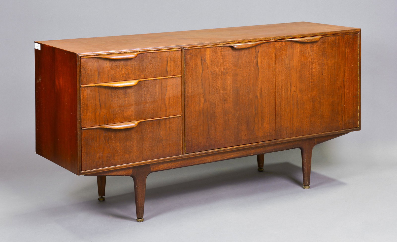 Mid Century Sideboard by McIntosh - "Dunvegan / Moy": This Danish Modern Style Teak Credenza / Cocktail Sideboard with folded handles is made by Scottish Mid Century Modern Furniture Maker McIntosh. It was designed by Tom Robertson, it is the Short "Dunv