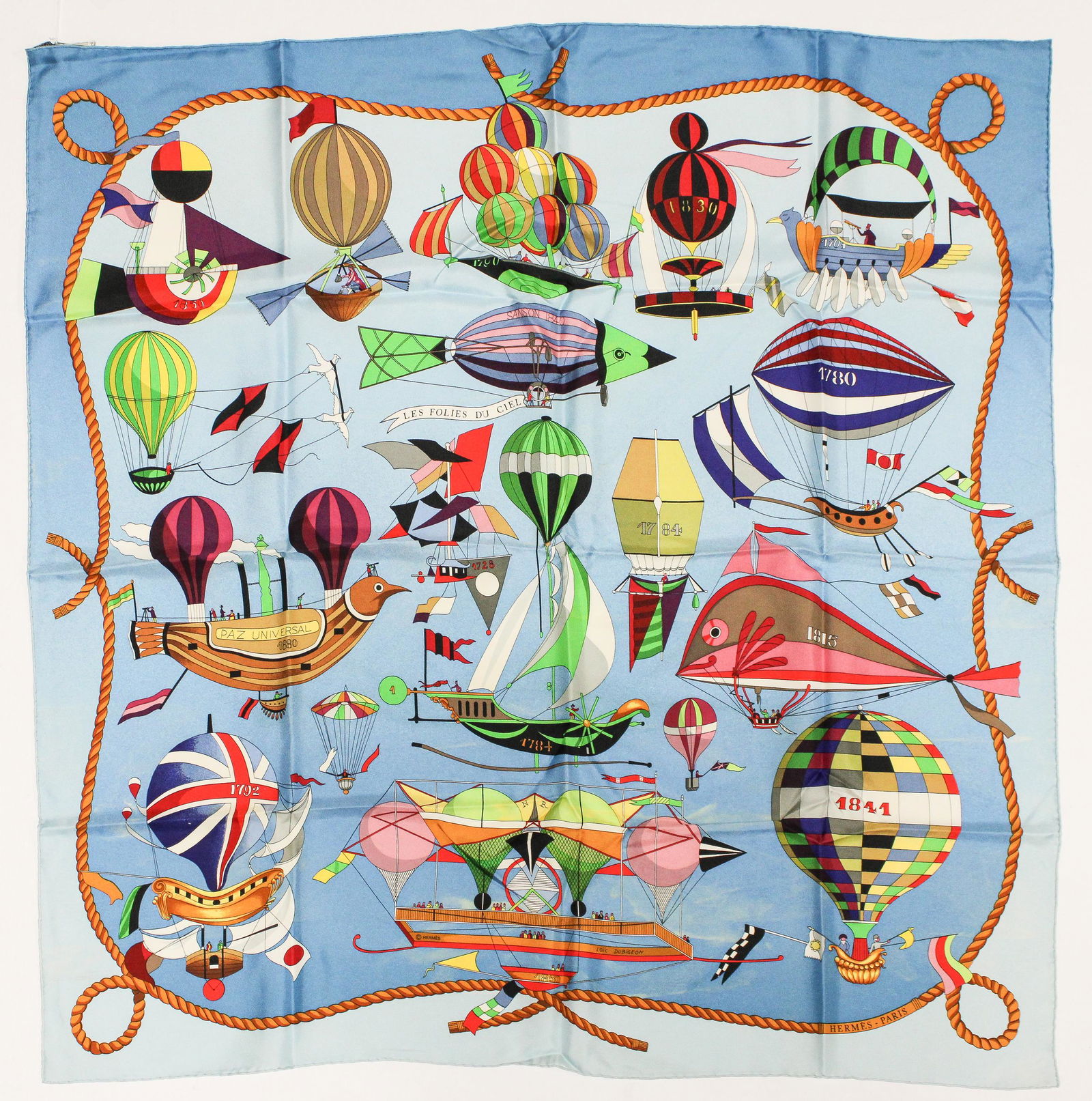 Hermes Scarf "Les Folies du Ciel" by Lo‹c Dubigeon: Genuine Pre-Owned Hermes Scarf in Blue/Green/Yellow 100% Twill Silk in A condition. Pattern / Title is "Les Folies du Ciel" by Lo‹c Dubigeon Measurements: 90*90cm (Length * Height * Width). This lot