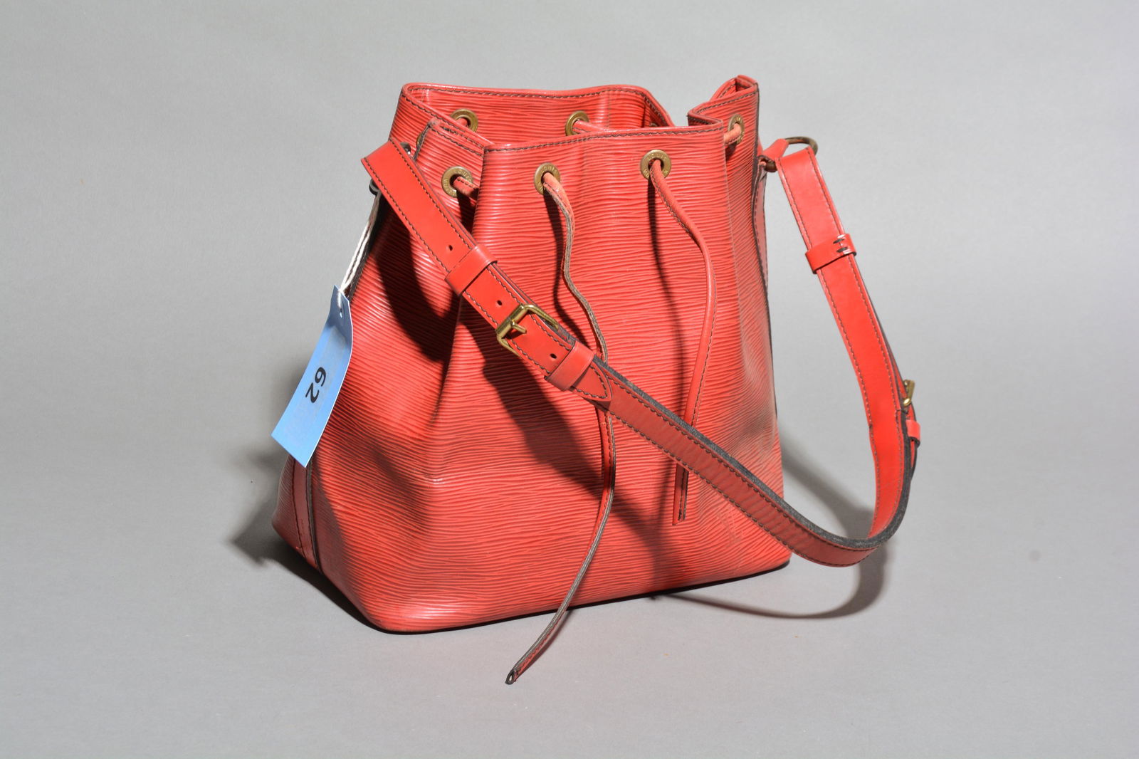 Louis Vuitton Noe Black Stitching PM in Red Epi: Genuine Pre-Owned Louis Vuitton Noe Black Stitching PM in Red Epi in AB condition. Date Code is A21921 (December 1991) Measurements: 24*26*18cm (Length * Height * Width). This lot includes a certifica