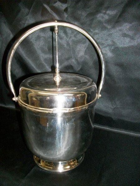 Unusual Dbl Hindged S/P Ice Bucket & Bar Tool Set: Made in USA by English Silver MFG Corp. Silver Plated Ice Bucket with Glass Liner. Lid Hindged in two directions, to reveal bar tools set or ice compartment. 14" overall height, 9" diameter. Four Vert