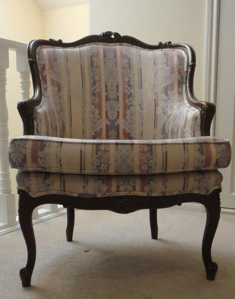 Antique LXV Style Gilt Wood Bergere en Gondole: Turn-of-century French Louis XV style. Gilt and gessoed finger carved frame with rococo crest, apron and knees; life carved arms. Horseshoe seat, raised on cabriole legs with padded brocade upholstery