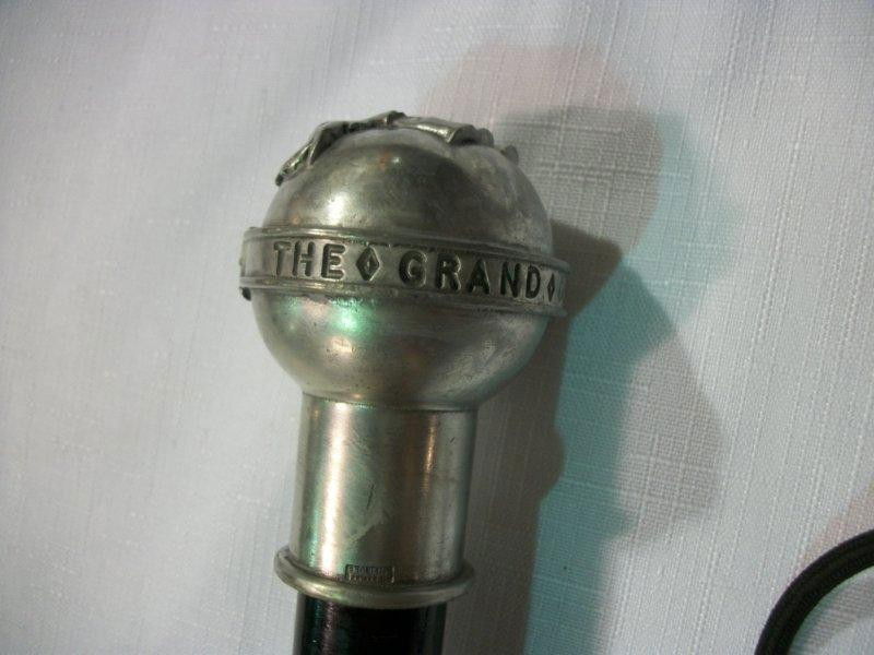 Amusing Cast Pewter Knob Handle Walking Stick,: 20th C., the polished pewter knob having an elephant in relief, with a tightened belt around the knob's perimeter, the belt with the words: "The Grand Old Party", mounted on an ebonized wood tapering