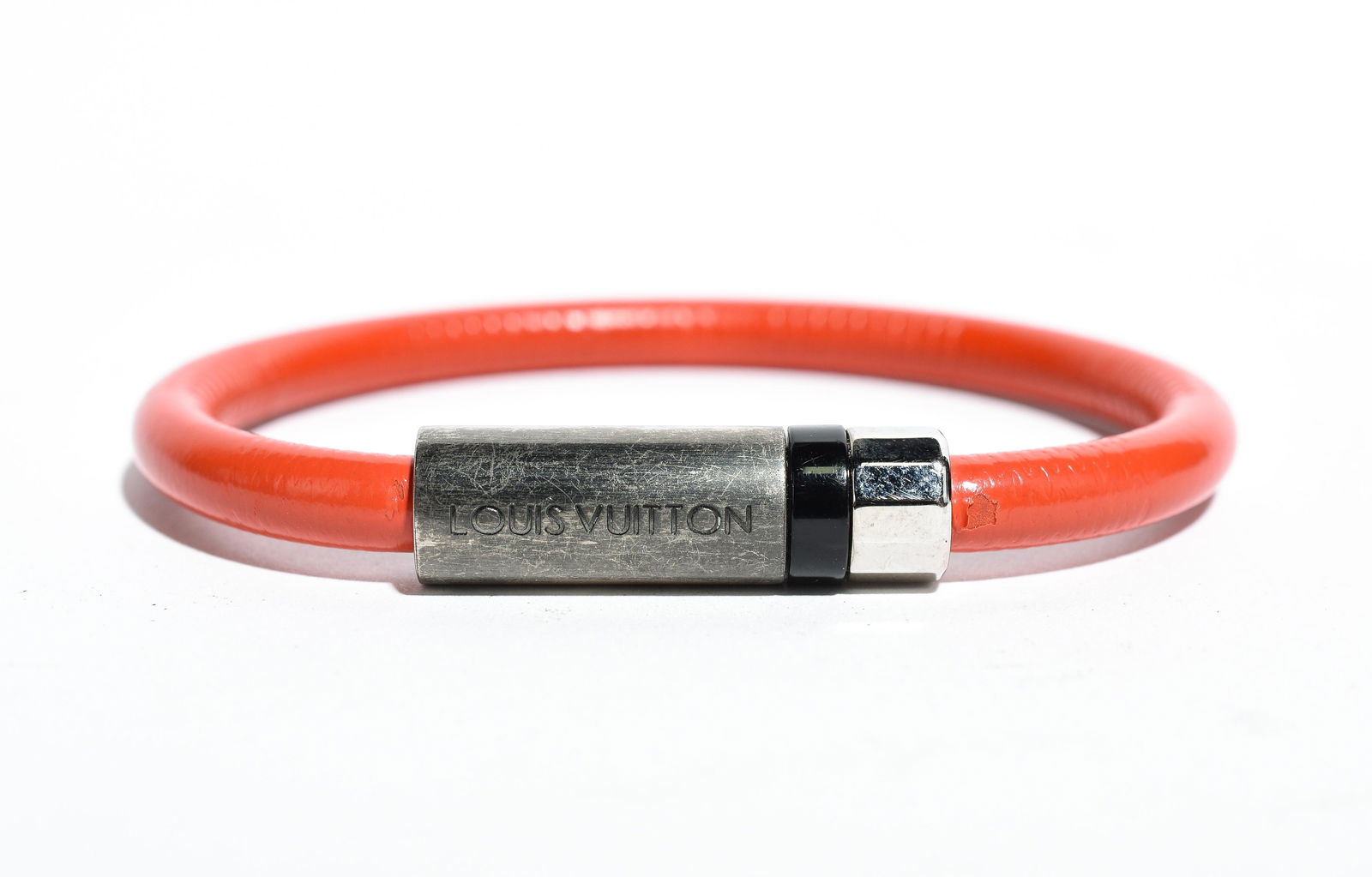 Louis Vuitton Confidental Bracelet: Genuine Pre-Owned Louis Vuitton Confidental Bracelet in Orange/Silver Calf Leather in A condition. Date Code is N/A Measurements: Close Length: 6.5cm (Length * Height * Width). This lot includes a cer