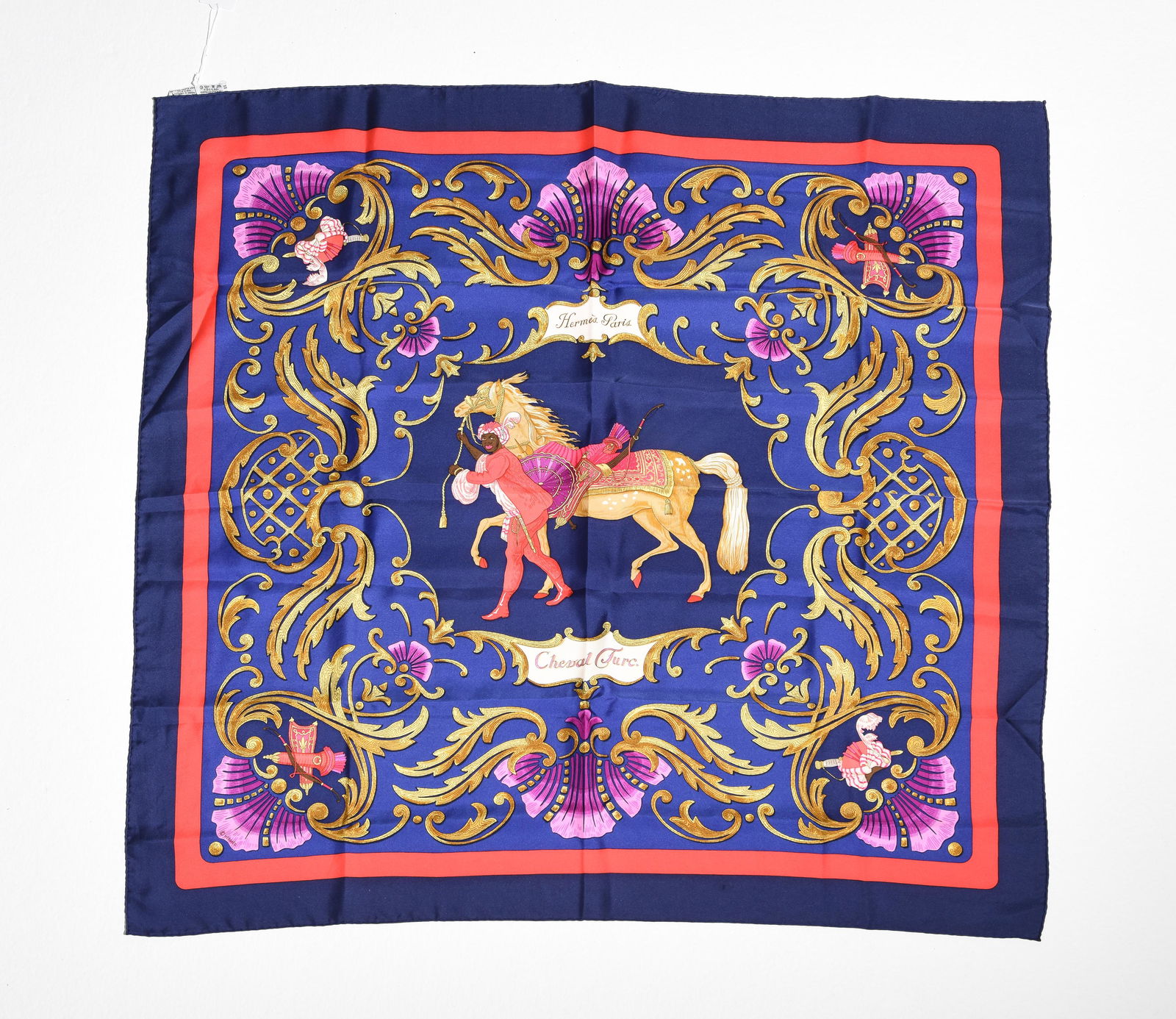 Hermes Scarf "Cheval Turc" by Christiane Vauzelles: Genuine Pre-Owned Hermes Scarf in Navy/Red/Purple/Gold/Pink 100% Twill Silk in A condition. Pattern / Title is "Cheval Turc" by Christiane Vauzelles Measurements: 90*90cm (Length * Height * Width). Th