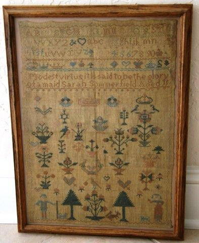 Geo III Alphabet Sampler circa 1800: Antique British oak framed sampler; Wood frame measures 20.25 x 14.25 x 1 in.; Sampler measures 12 x 16.75 in.; the design incorporates an alphabet theme and depicts a man and a woman at the bottom, a