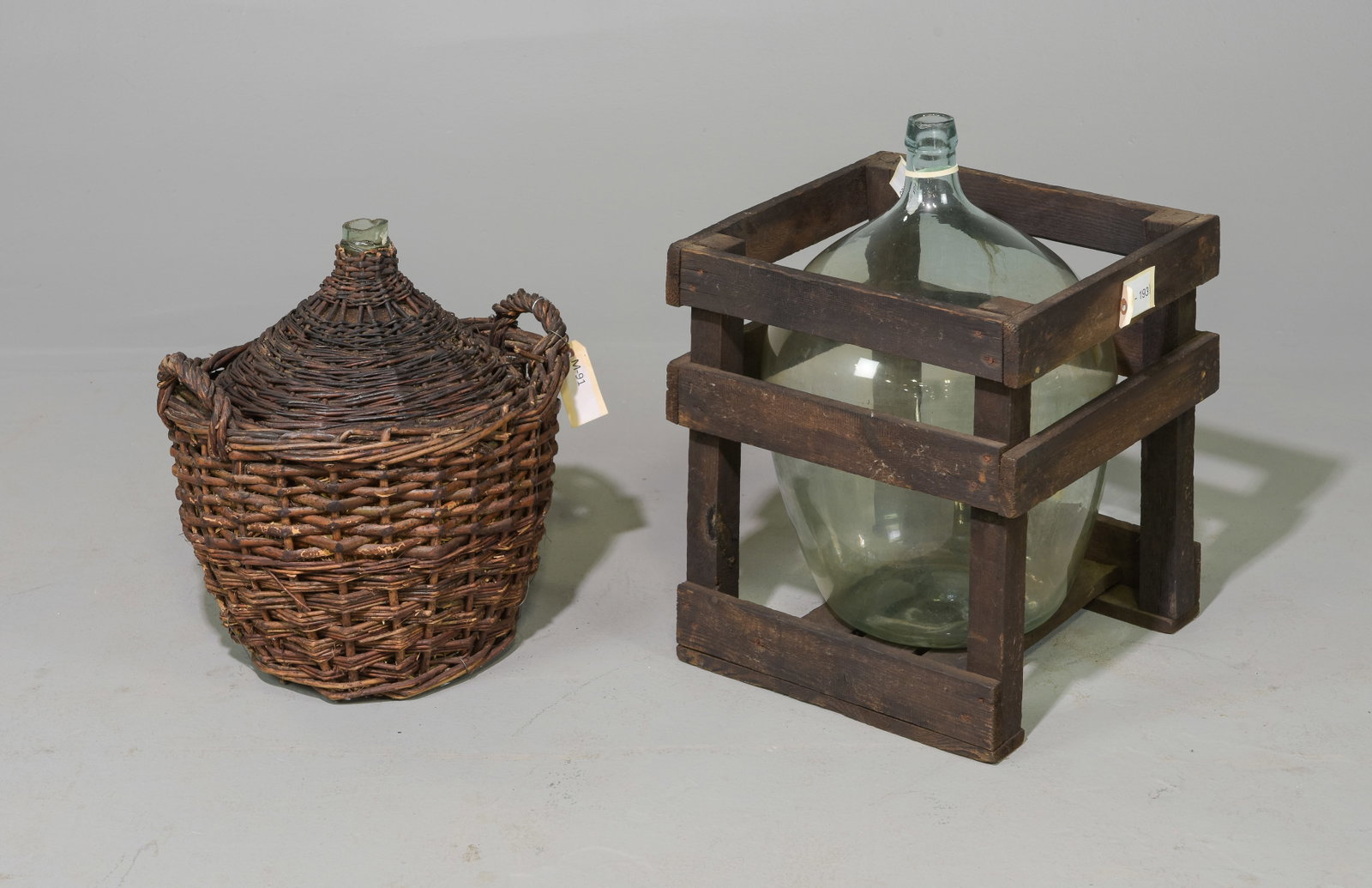 Glass Demijohn in Basket & Glass Demijohn in Crate: Glass Demijohn / Bottle in Basket & Glass Demijohn / Bottle in Crate - 21 in tall x 15 x 16 and 17 in tall x 16 inch diameter