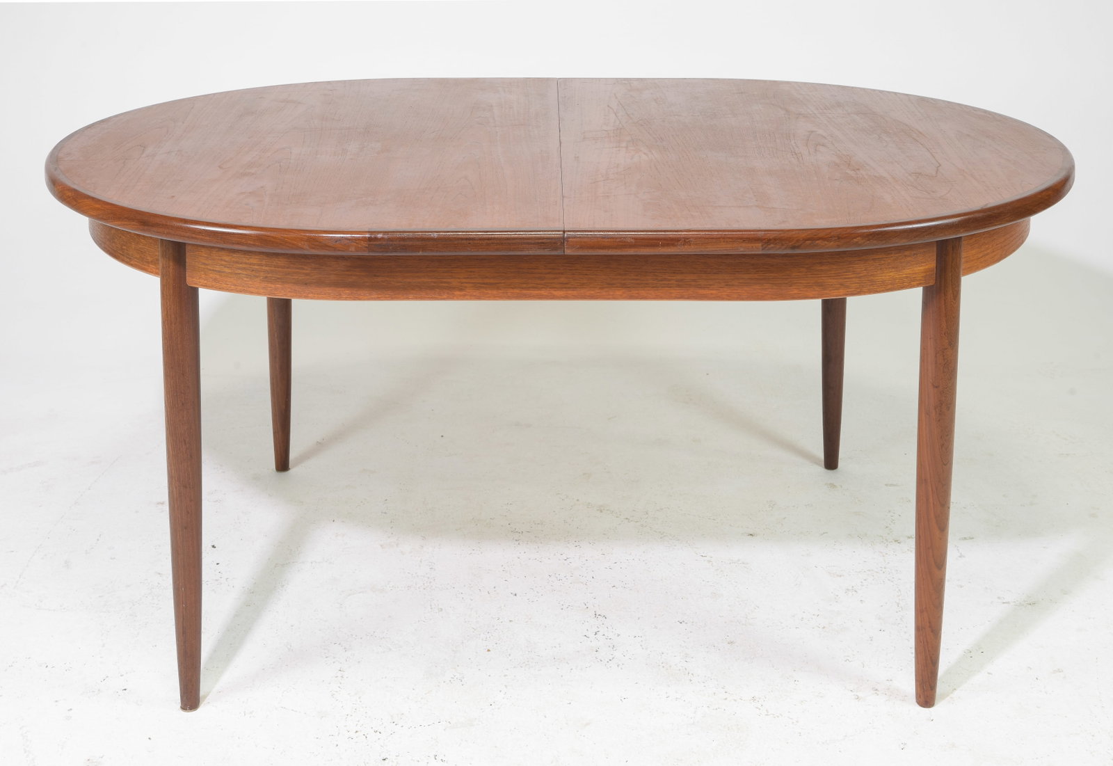 Oval Mid Century Teak Dining Table By G-Plan: This Danish Modern Style Teak Dining Table includes a pop-out butterfly style leaf & is made by Mid Century Modern Furniture Maker G Plan ( GPlan ), part of their fresco range . - 29 in tall x 65 x 42