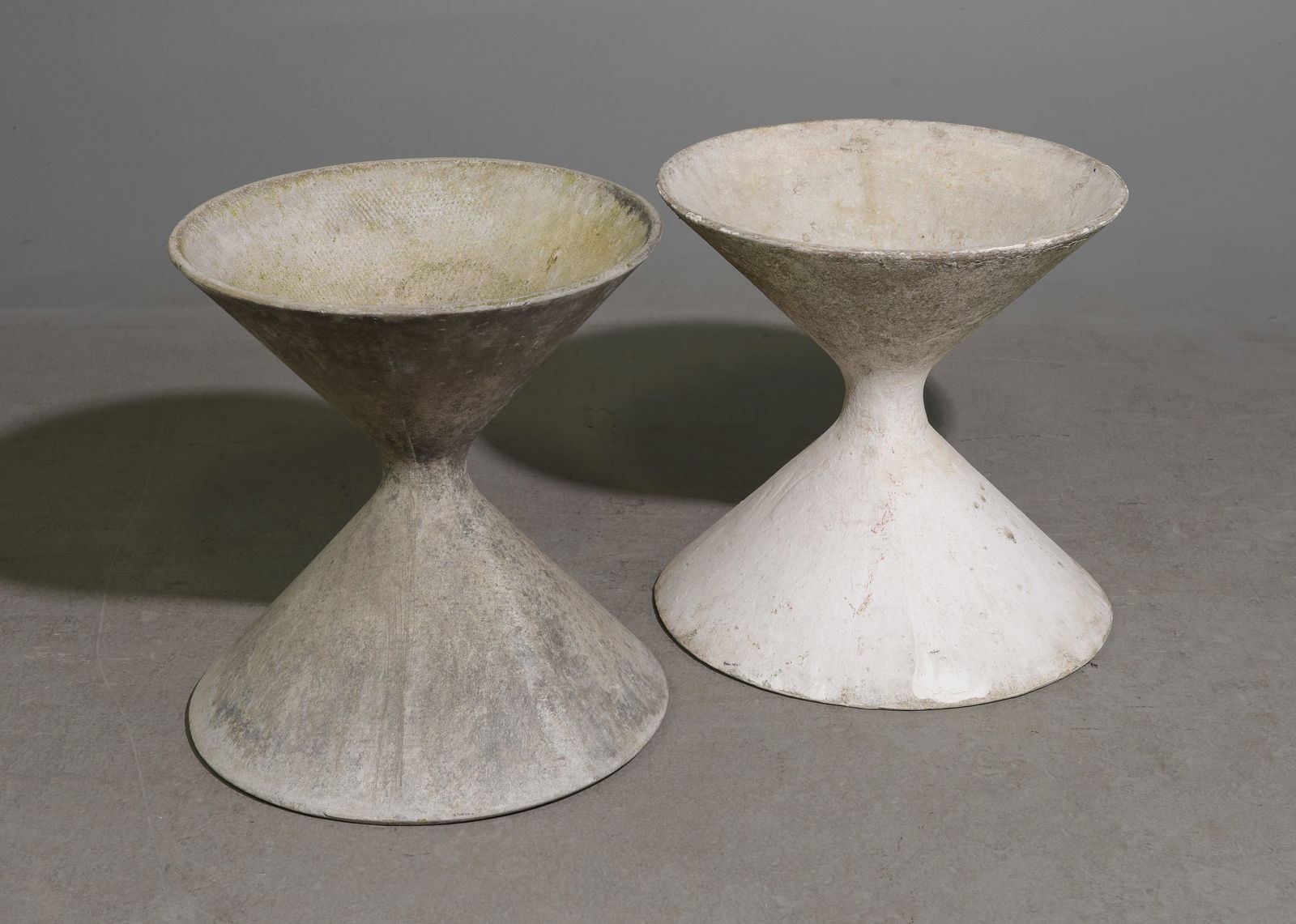 Willy Guhl (1915-2004) - 2 Diabolo Planters: Willy Guhl (1915-2004) Switzerland - 2 Diabolo (Diablo) Planters - 19 in tall x 18 inch diameter and 18.5 in tall x 18.5 inch diameter - Much of his work is crafted from either concrete or Eternit.