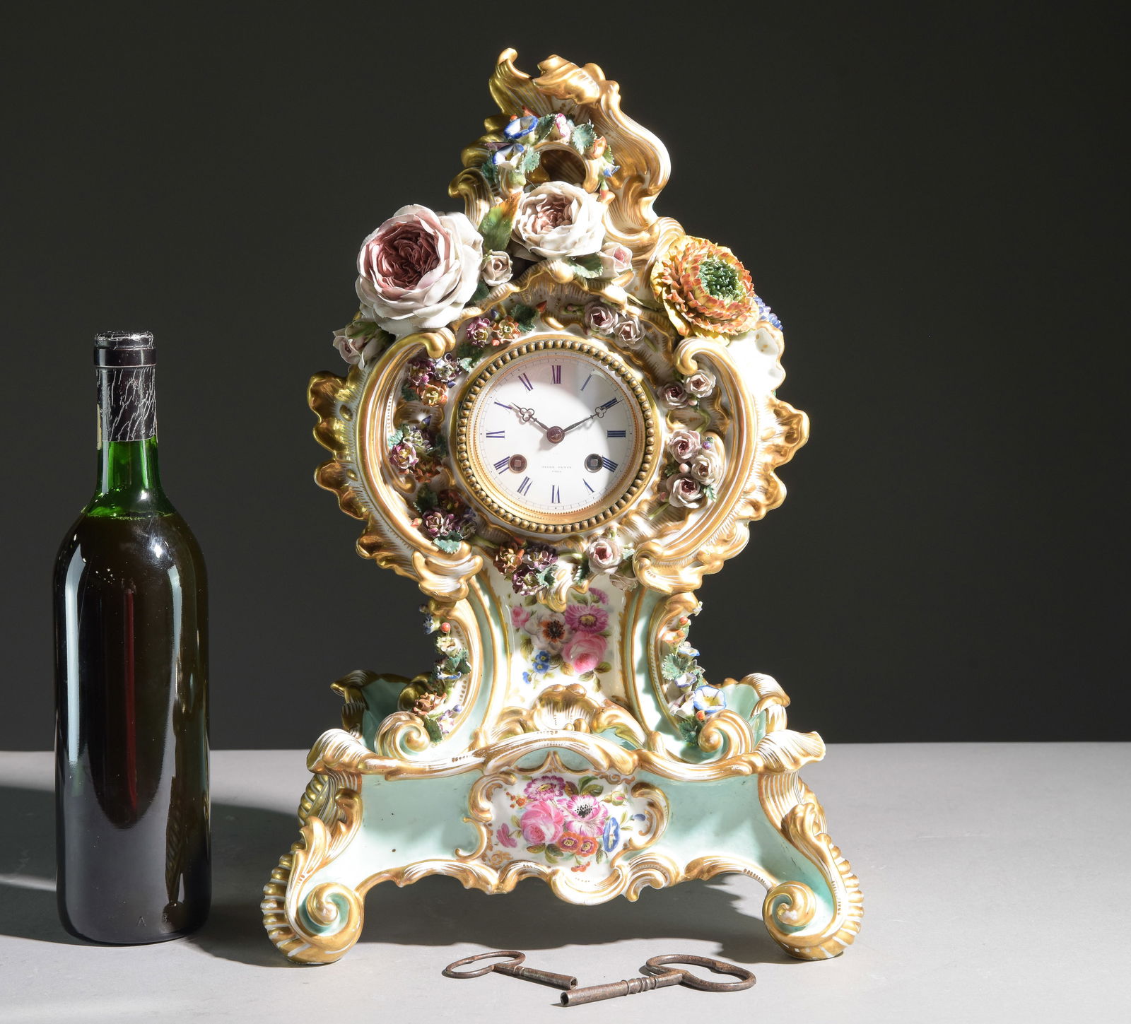 Jacob Petit Floral Adorned Porcelain Mantel Clock: Jacob Petit Floral Adorned Porcelain Mantel Clock - The clock itself is 13.75 in tall x 9.25 x 6, The base is 4.5 in tall x 11.25 x 9, Together the height is 18.25 inches