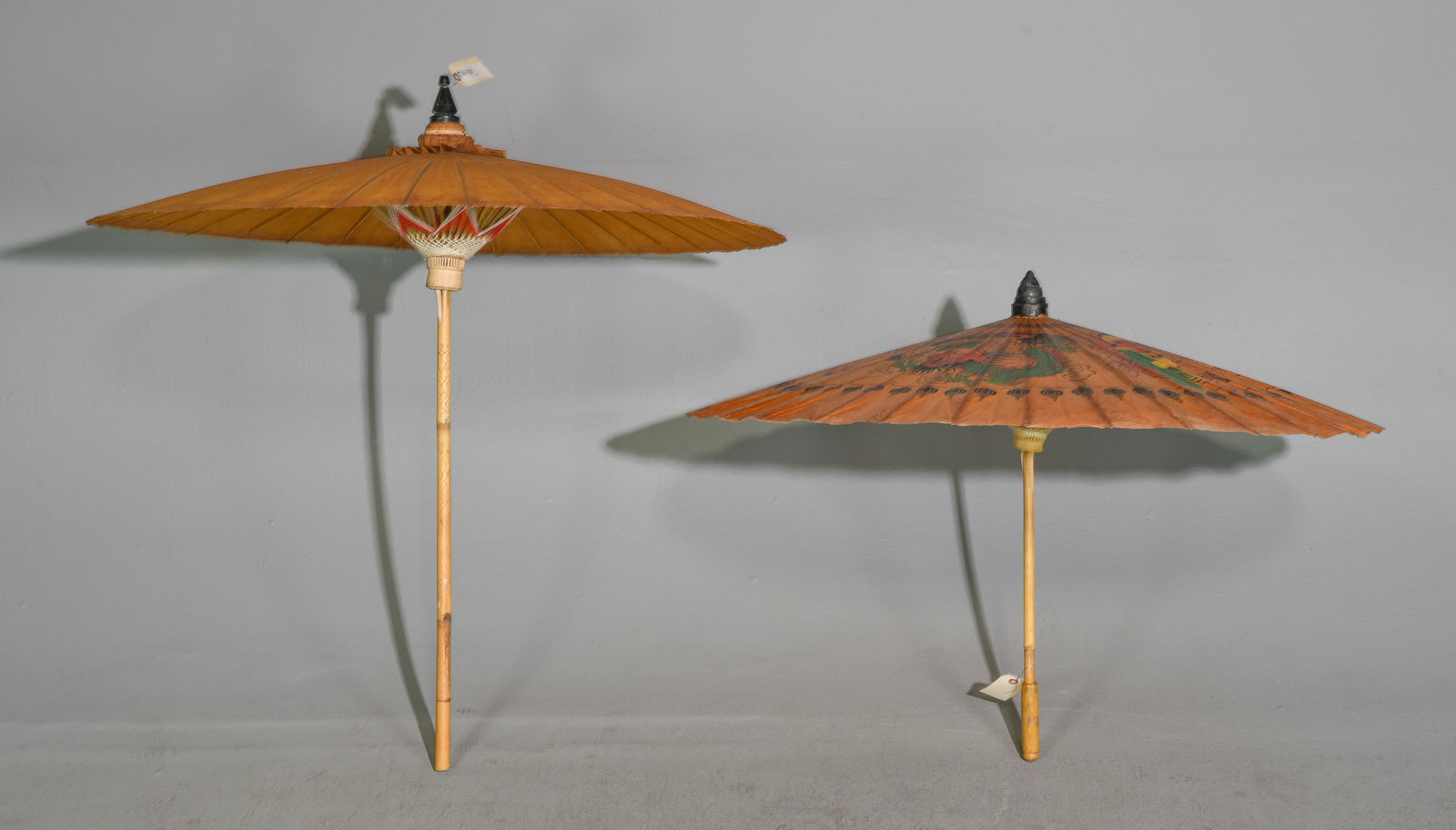 Two Chinese Oil Paper Umbrellas / Parasols: Two Chinese Oil Paper Umbrellas / Parasols - Largest is 39 inches long by 3 inch diameter when closed