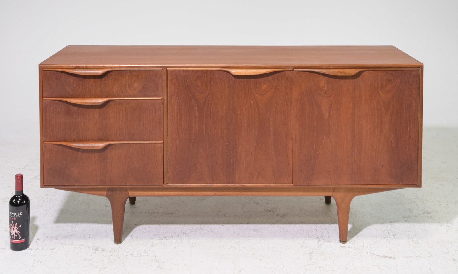 Mid Century Sideboard by McIntosh - "Dunvegan / Moy": This Danish Modern Style Teak Credenza / Cocktail Sideboard with folded handles is made by Scottish Mid Century Modern Furniture Maker McIntosh. It was designed by Tom Robertson, it is the Short "Dunv