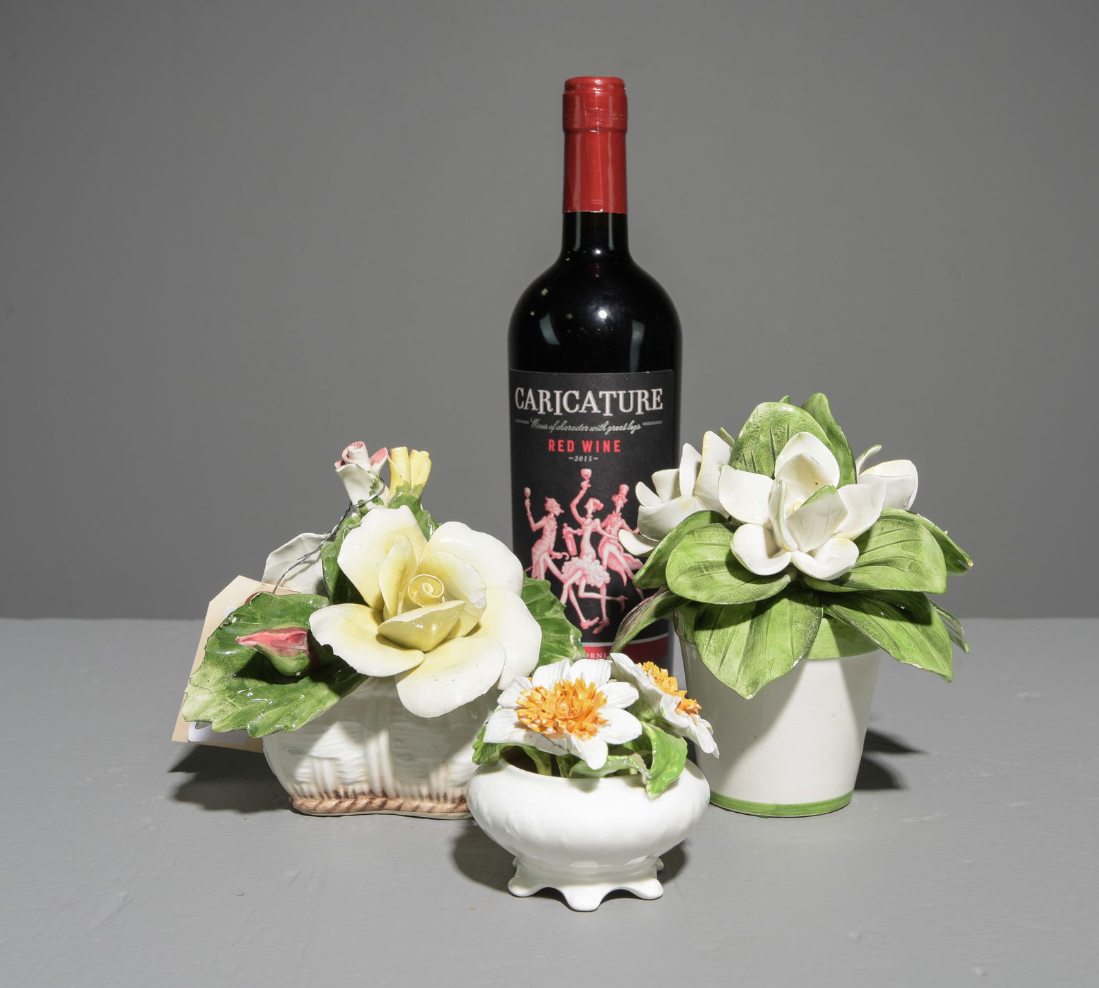 Three Floral Decorative Porcelain Figures: Three Floral Decorative Porcelain Figures - One is Nuova Capodimonte, a hand made Radnor bone china Staffordshire piece and an Italian Leanne Reeds piece - 6.5 in tall x 6 inch diameter, 6 in tall x 6