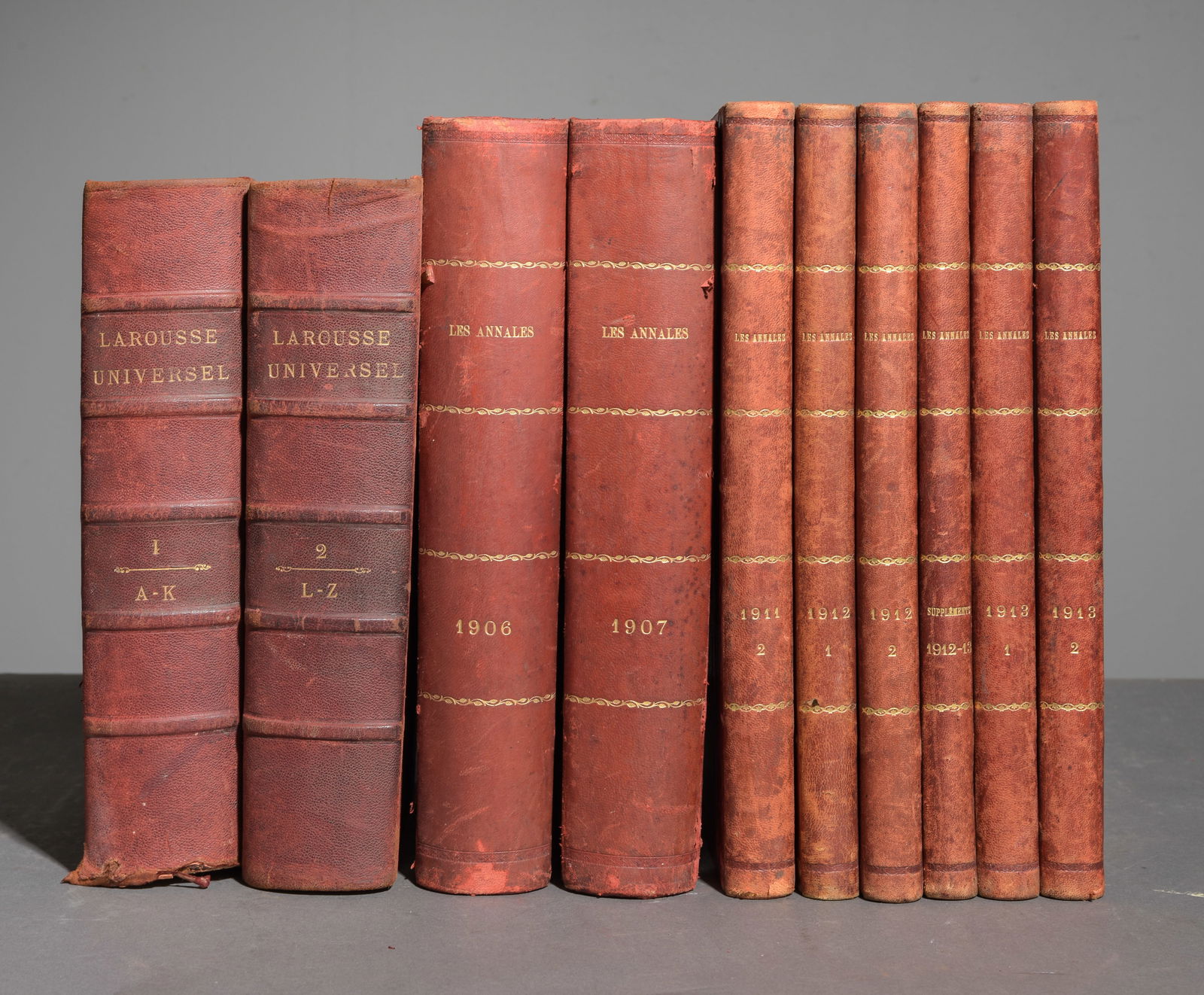 10 French Red Leather Bound Books: 10 French Red Leather Bound Books c.1900-1910's - Largest is 13 in tall x 10 x 2.5 - "Les Annales" and "Larousse Universel"