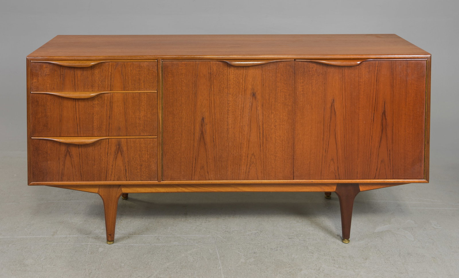 Mid Century Sideboard by McIntosh - "Dunvegan / Moy": This Danish Modern Style Teak Credenza / Cocktail Sideboard with folded handles is made by Scottish Mid Century Modern Furniture Maker McIntosh. It was designed by Tom Robertson, it is the Short "Dunv