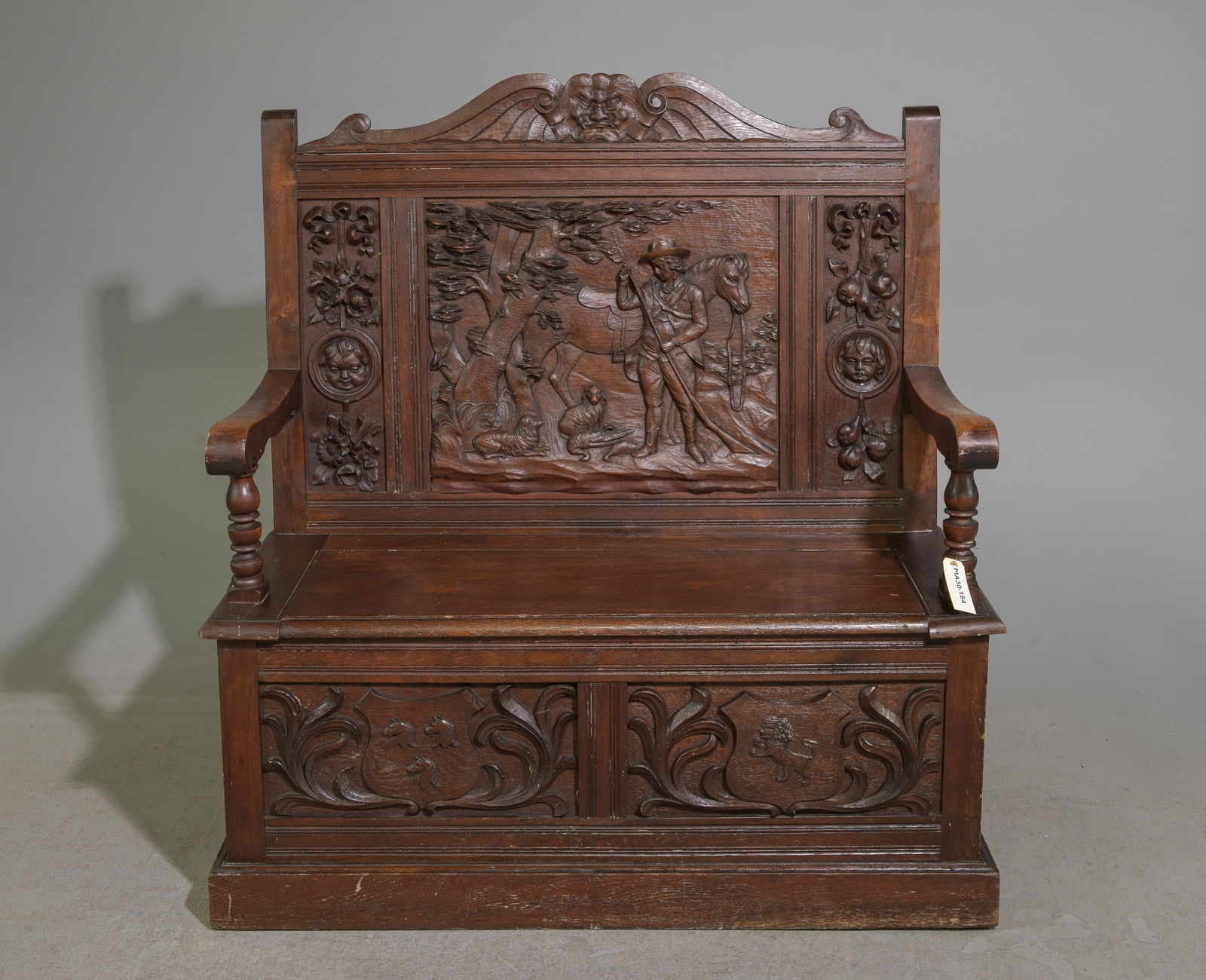 English Finely Carved Oak Hall Bench: English Finely Carved Oak Hunting Hall Bench with Lift Seat featuring a pictural relief back of a hunter with his horse and dogs - 47 in tall x 43.5 x 18, seat height is